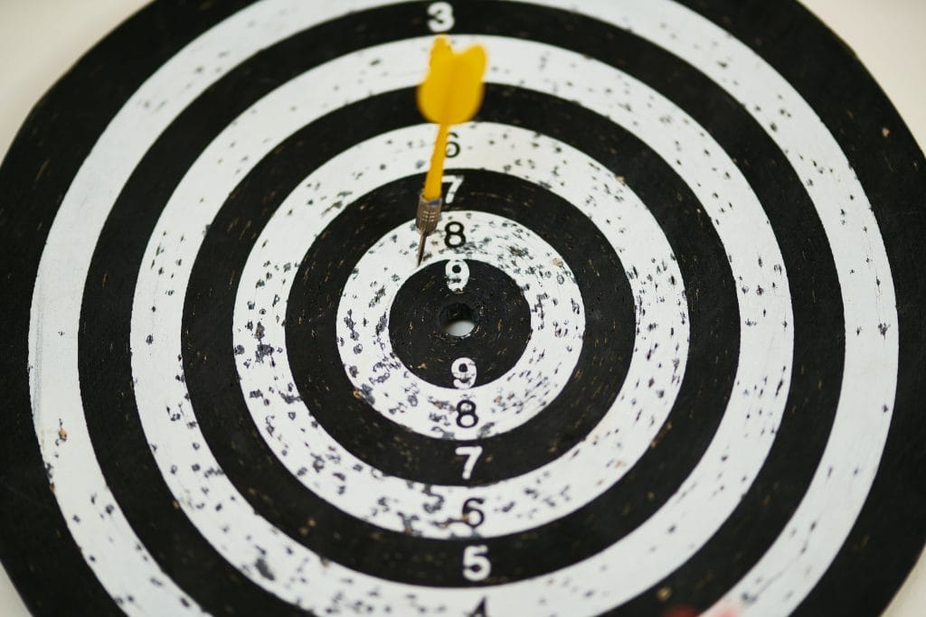 A dart precisely hits the bullseye of a target, showcasing accuracy and precision in this image.