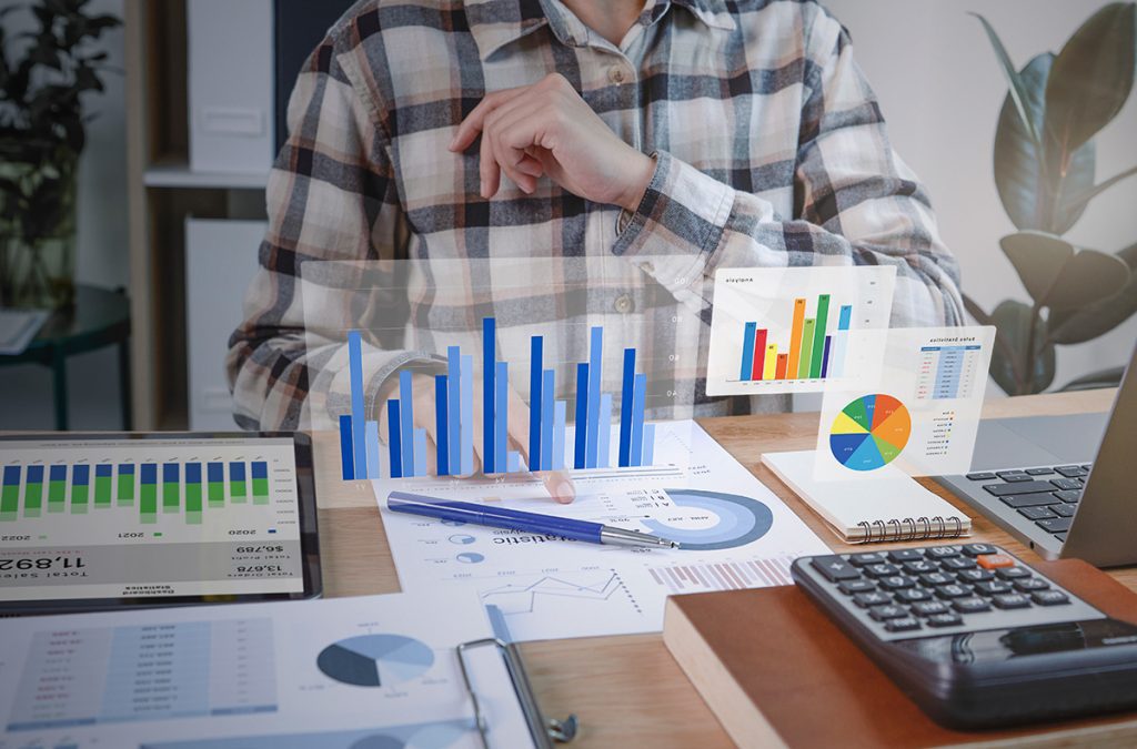 A man analyzing data on a laptop, studying graphs and charts to gain insights and make informed decisions.