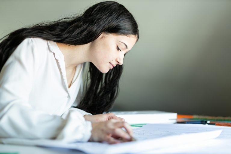 a woman writing on a paper