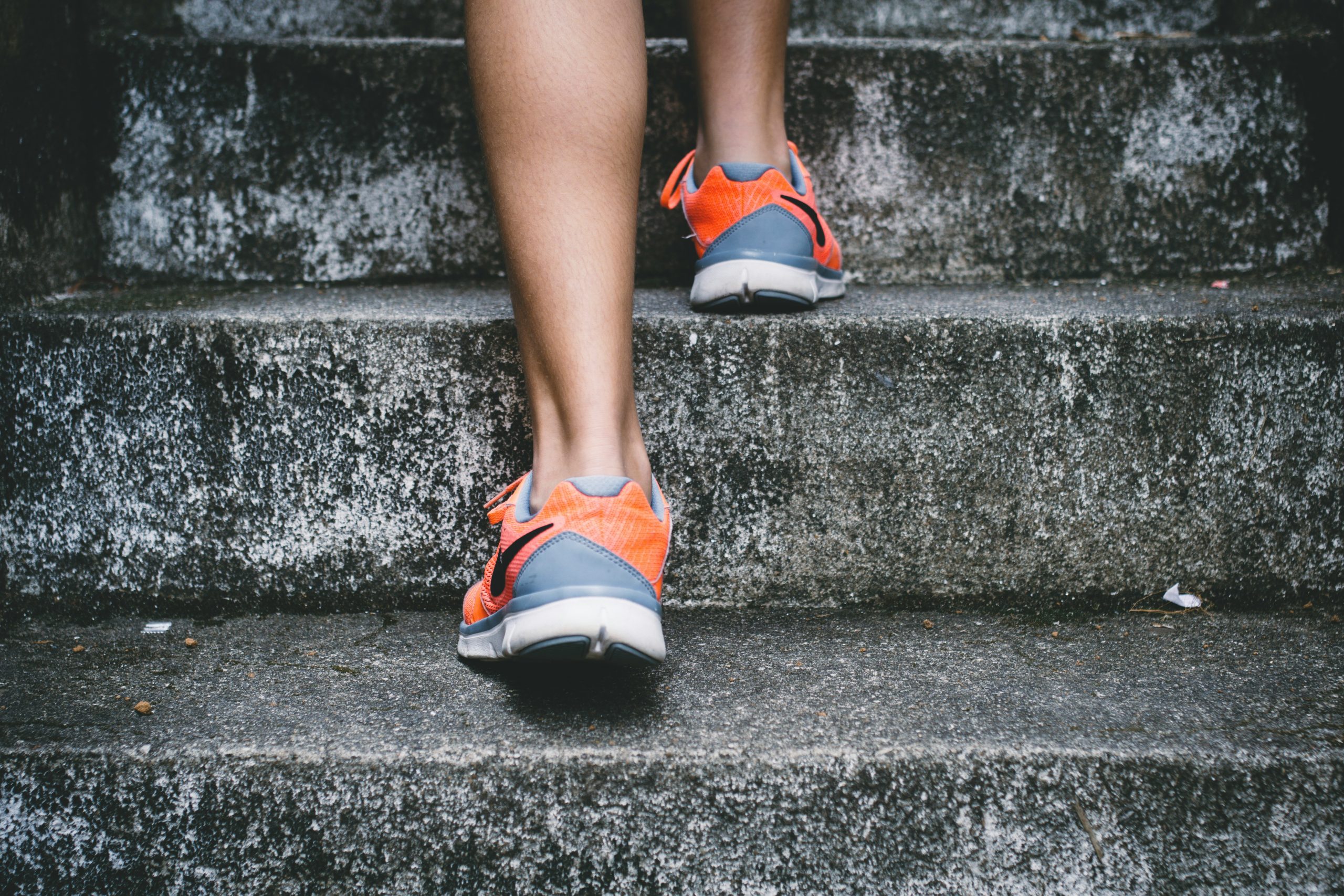 a person's legs and shoes on stairs