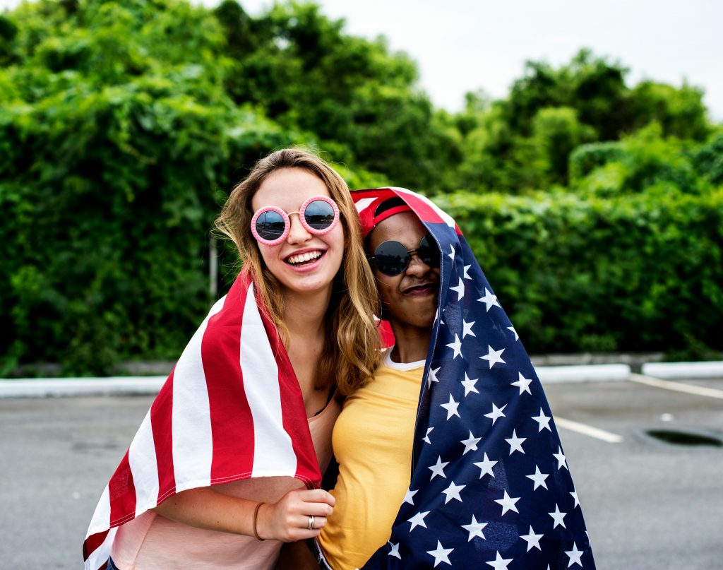 Can I Apply For U.S. Citizenship After 3 Years Of Green Card? two women holding a flag