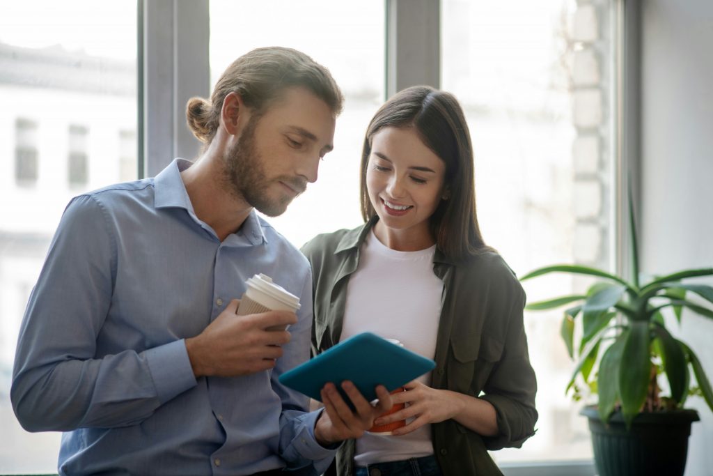 a man and woman looking at a tablet
