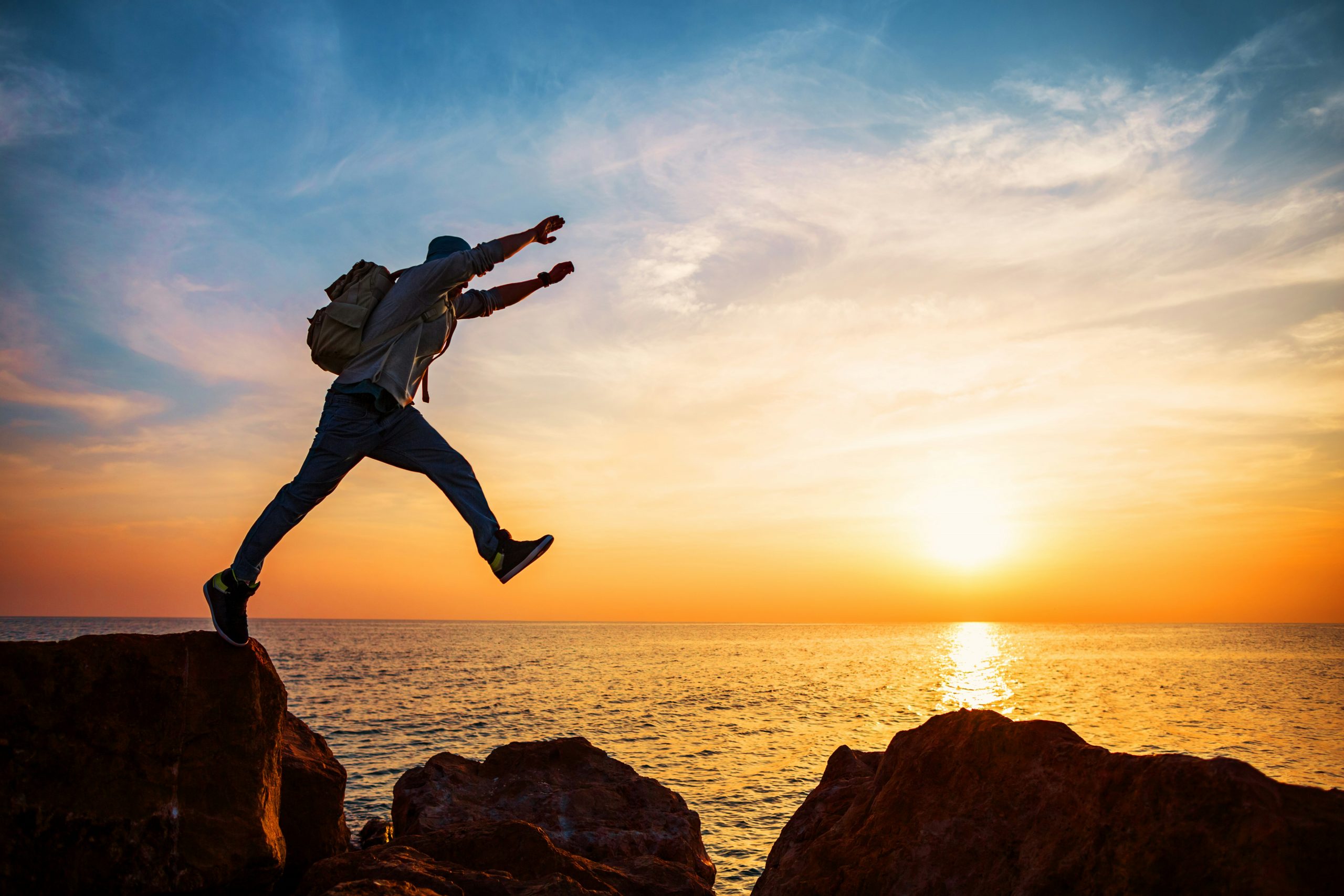 a person jumping off a rock