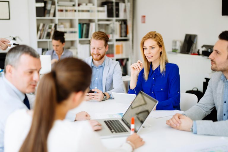 a group of people sitting around a table