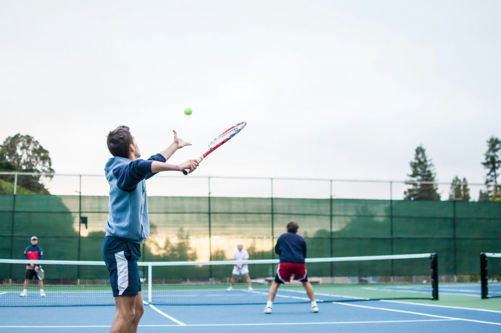 Navigating Pitfalls: Key Issues in National Interest Waiver Eligibility Assessment a man hitting a tennis ball with a racket