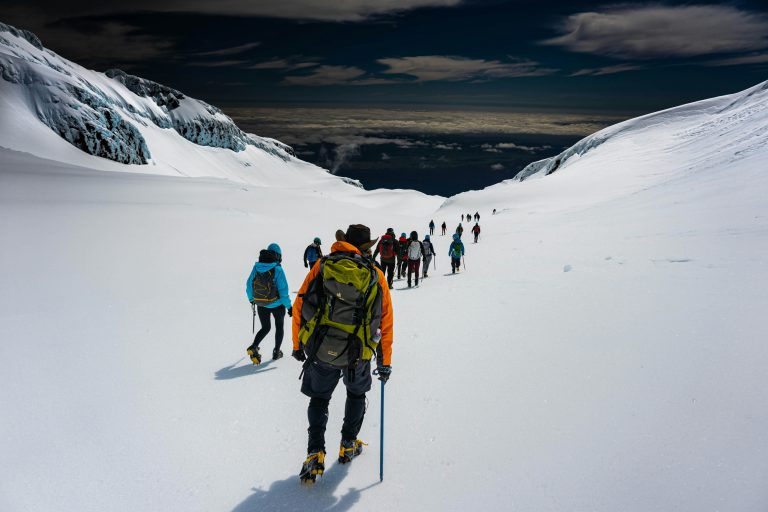 a group of people hiking on a snowy mountain