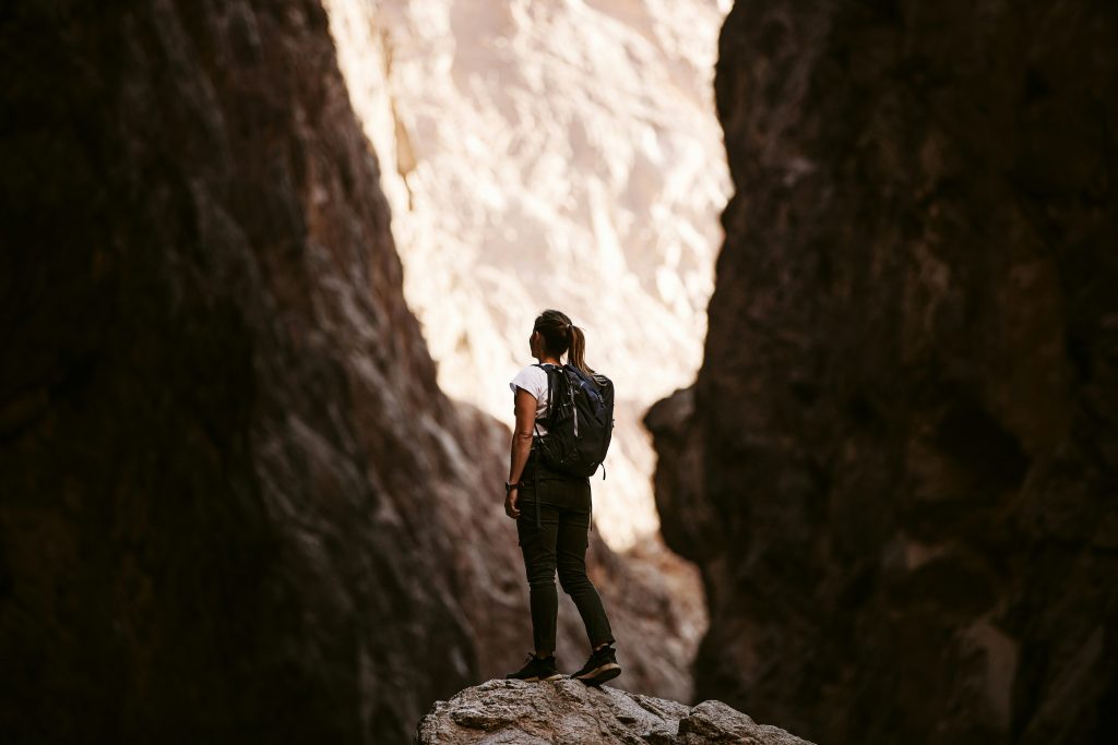 a woman standing on a rock