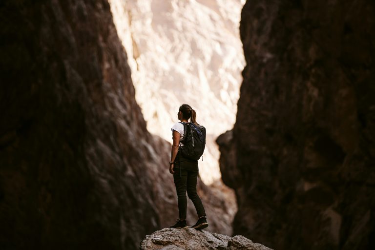 a woman standing on a rock