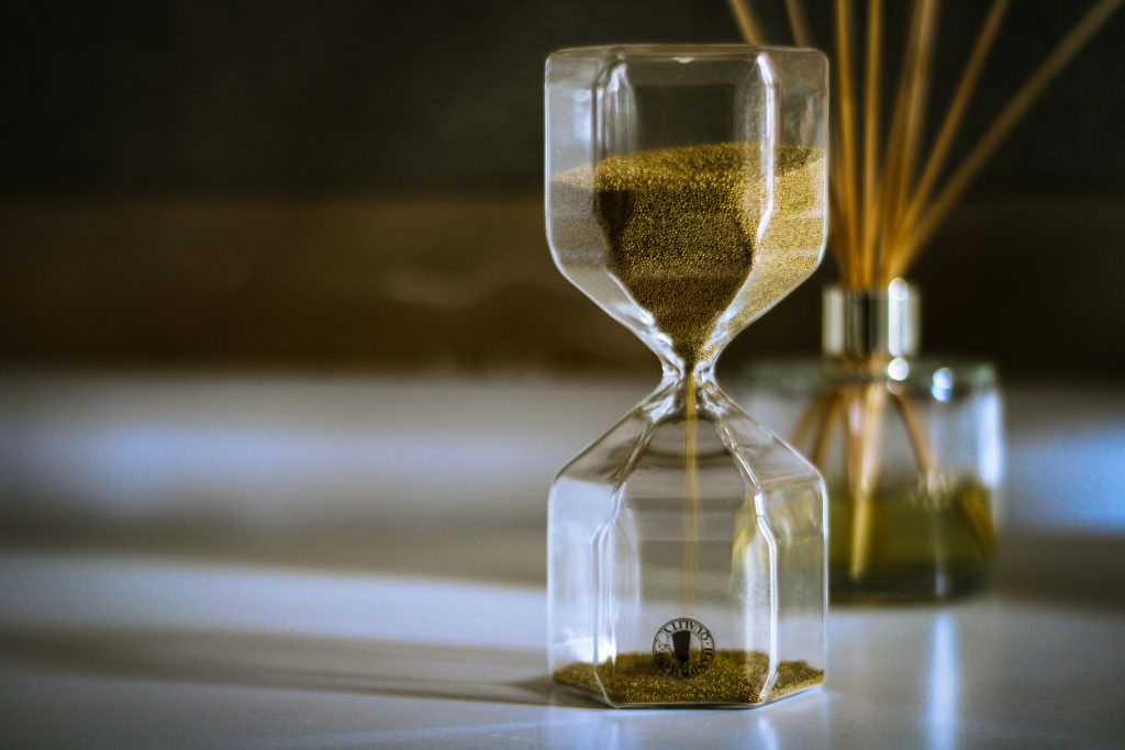 a sand clock with a gold sand in the middle