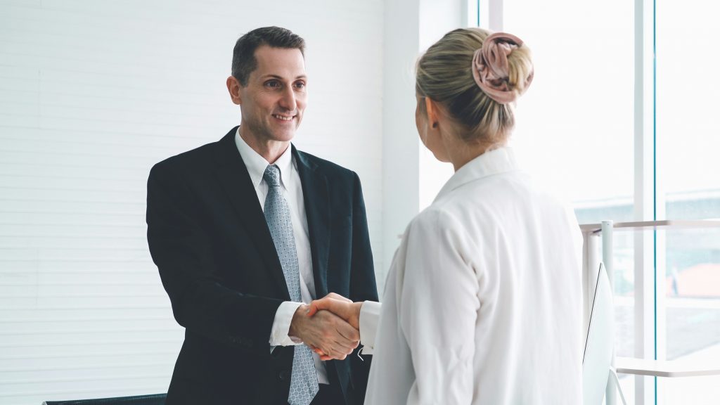 a man and woman shaking hands